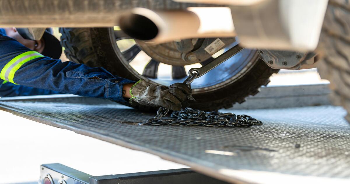 A mechanic checking for bad control arm symptoms.