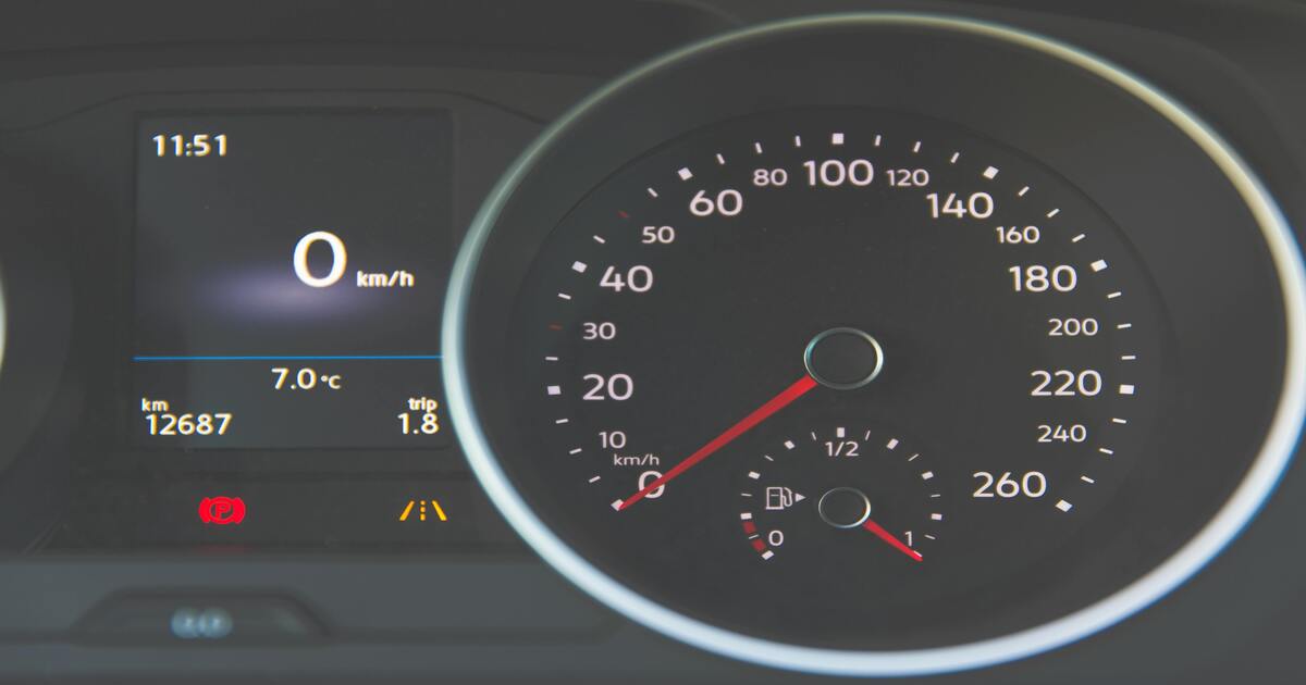 A car dashboard showing one common sign of a clogged catalytic converter - bad fuel economy.