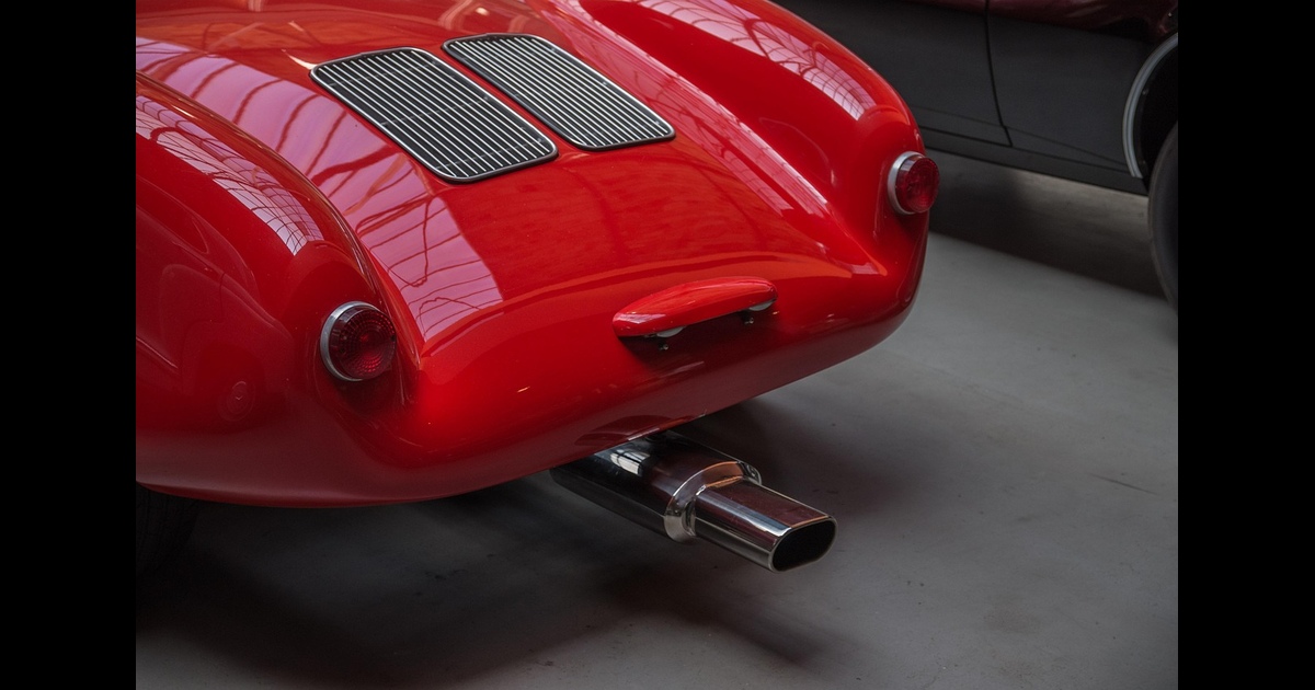 A unique exhaust on a sports car positioned in the center of the vehicle.